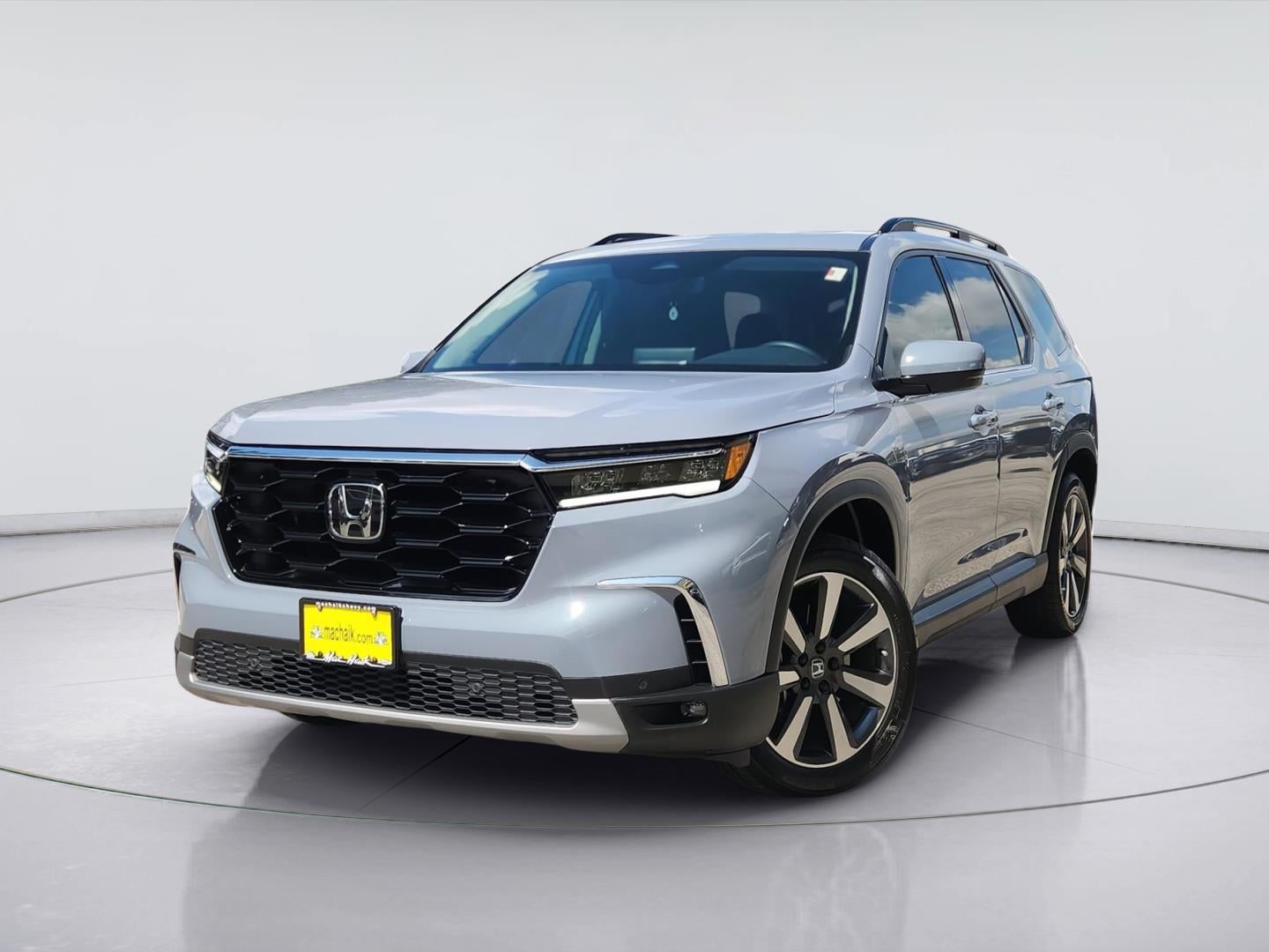 2025 Honda Pilot Touring in Sonic Gray Pearl — front three-quarter view