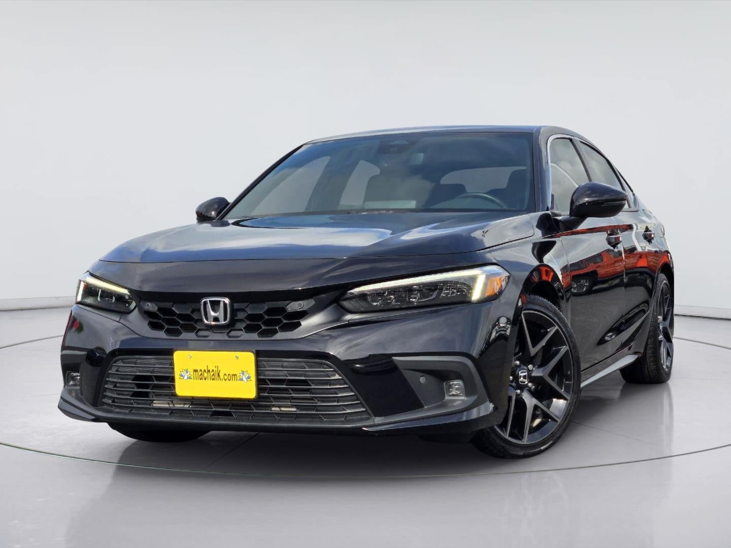 2024 Honda Civic Sport Touring in Crystal Black Pearl — front three-quarter view